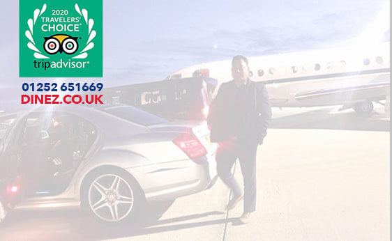 24 hours taxi near me, a chauffeur walking back to his executive car with a backdrop of a private jet at Farnborough Airport