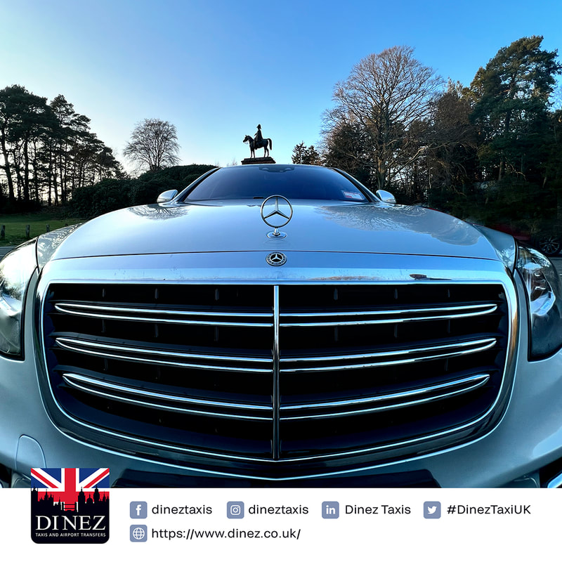 Showing off the hood of the Mercedes S Class 560e semi-electric with the Wellington Statue at the back drop.  Dinez Taxis and Airport Transfers logo